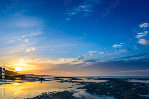 The sea and the beautiful expanse of blue sky with clouds and sunlight at sunset. Russia Azov sea.
