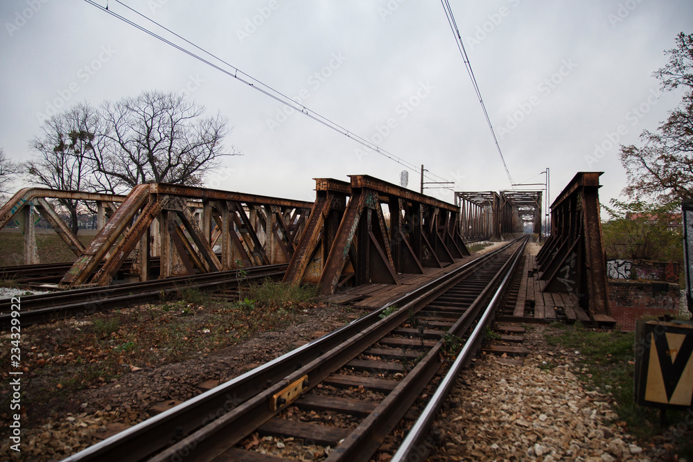 Old, rusty rails and metal structures of the bridge over the river in Wroclaw in the Nadodrze  area 