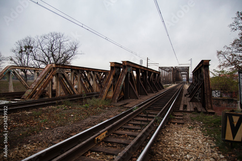 Old, rusty rails and metal structures of the bridge over the river in Wroclaw in the Nadodrze area 