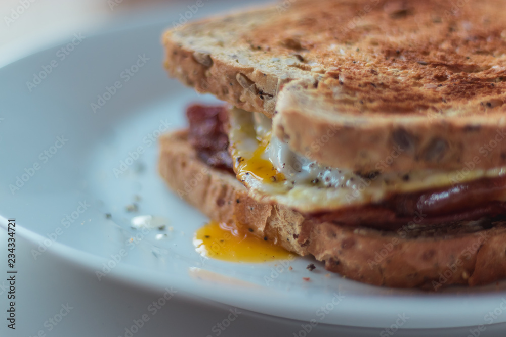 Homemade Breakfast Egg Sandwich with Cheese and bacon on Toast Homemade Breakfast Egg Sandwich with Cheese and bacon on Toast