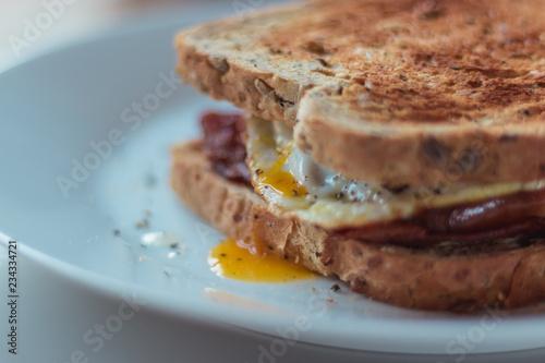Homemade Breakfast Egg Sandwich with Cheese and bacon on Toast