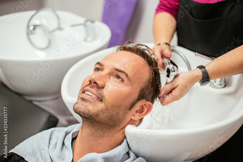 Man having his hair washed in a barbershop