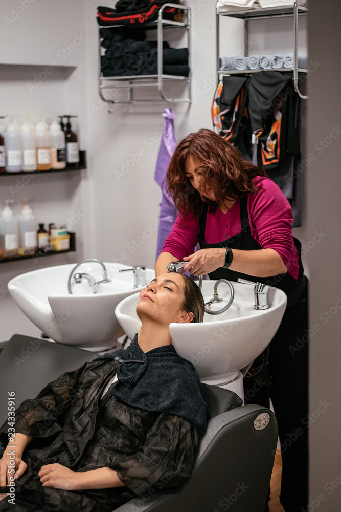 © DavidPrado - Woman having her hair washed in a salon