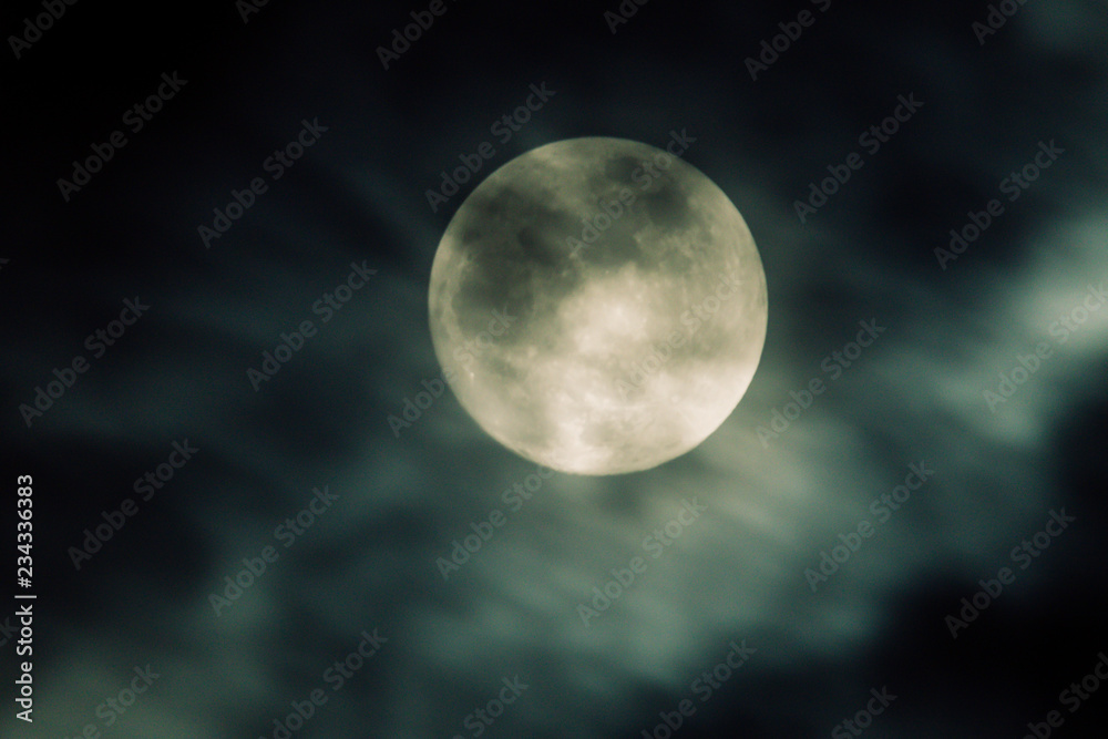 mystic full moon in the sky behiond some clouds or mist mystic full moon in the sky behiond some clouds or mist