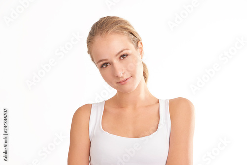 Young woman with beautiful face standing at isolated white background. Beauty shot.