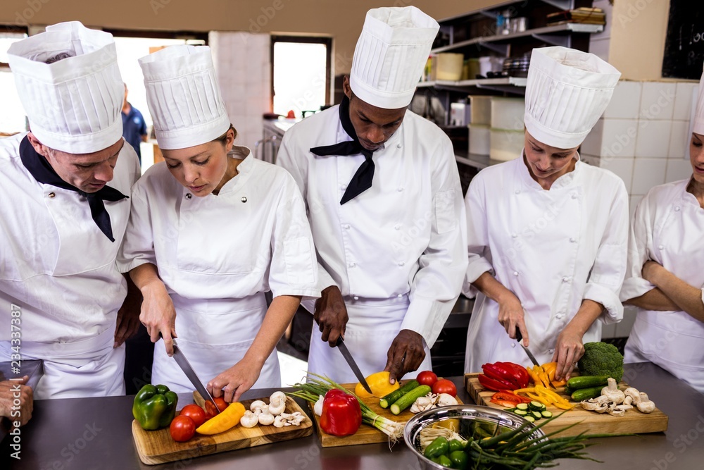 Chef chopping vegetable in kitchen Chef chopping vegetable in kitchen