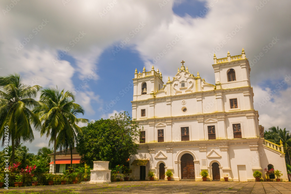 Ancient St. Thomas church landscape in Aldona Goa surrounded by monsoon clouds 