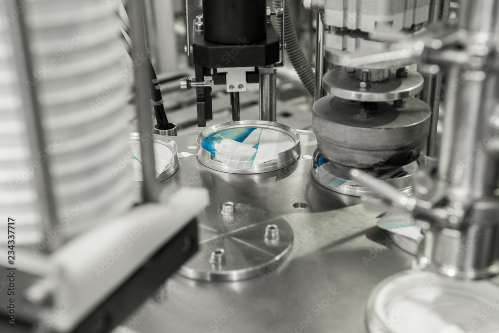 production and bottling of yogurt in plastic cups. equipment at the dairy plant production and bottling of yogurt in plastic cups. equipment at the dairy plant