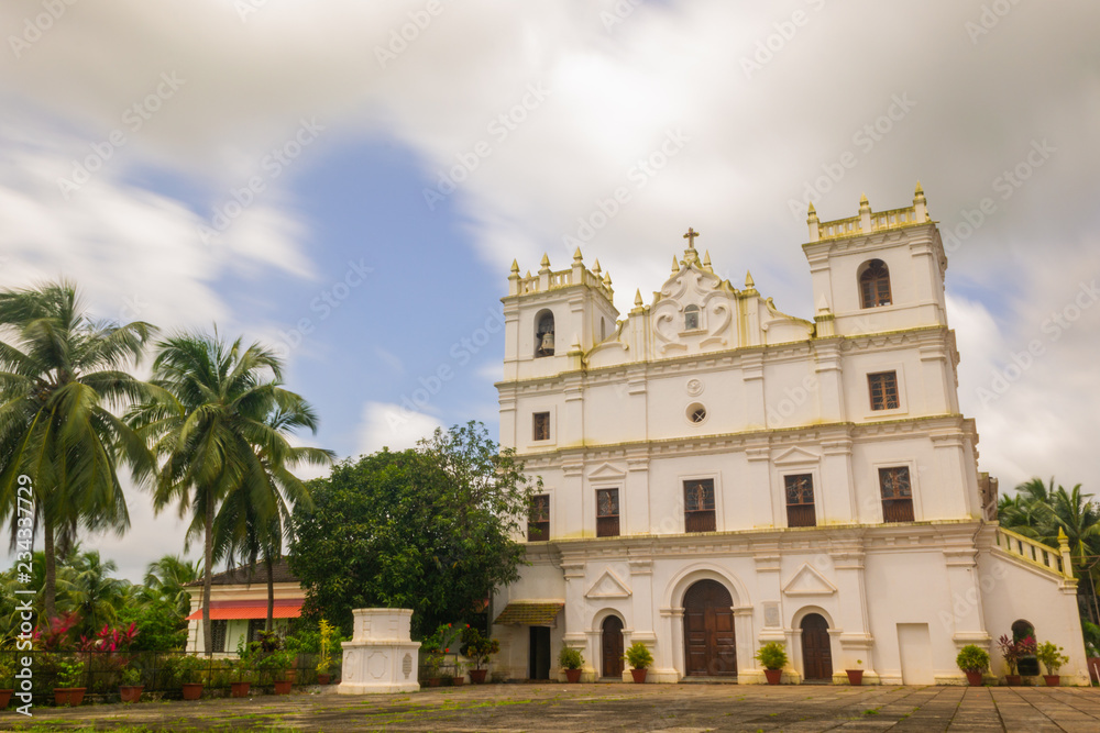 Ancient St. Thomas church landscape in Aldona Goa surrounded by monsoon clouds 