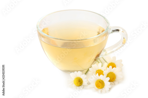 Cup of tea with chamomile flowers on white background