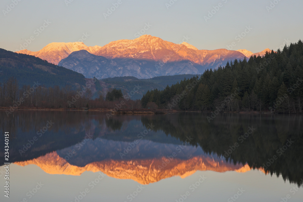 british columbia canada, one mile lake on the sea to sky highway at sunset, mountains in background with reflection in lake british columbia canada, one mile lake on the sea to sky highway at sunset, mountains in background with reflection in lake