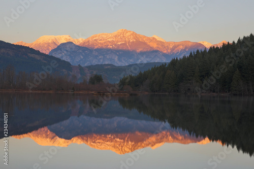 british columbia canada, one mile lake on the sea to sky highway at sunset, mountains in background with reflection in lake
