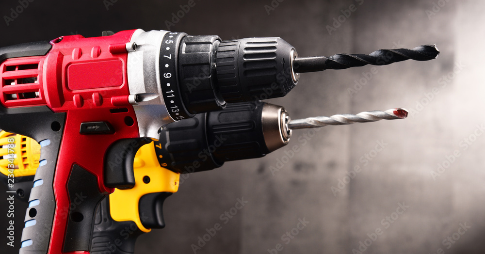 Two cordless drills with drill bits working also as screw guns - obrazy, fototapety, plakaty 