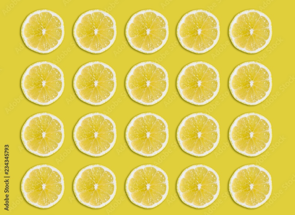 sliced lemon on yellow background