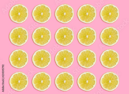 sliced lemon on pink background