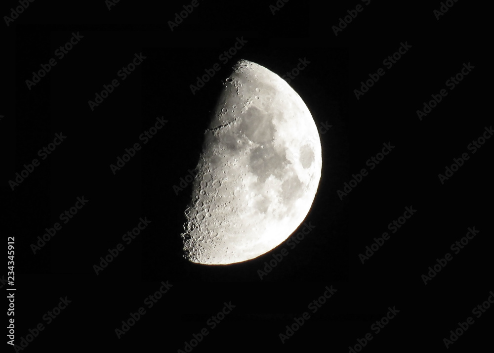 Silver waxing moon on black sky background Silver waxing moon on black sky background