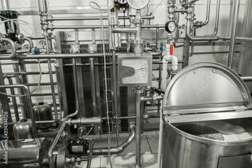 storage and pasteurization tank at the milk factory. equipment at the dairy plant photo