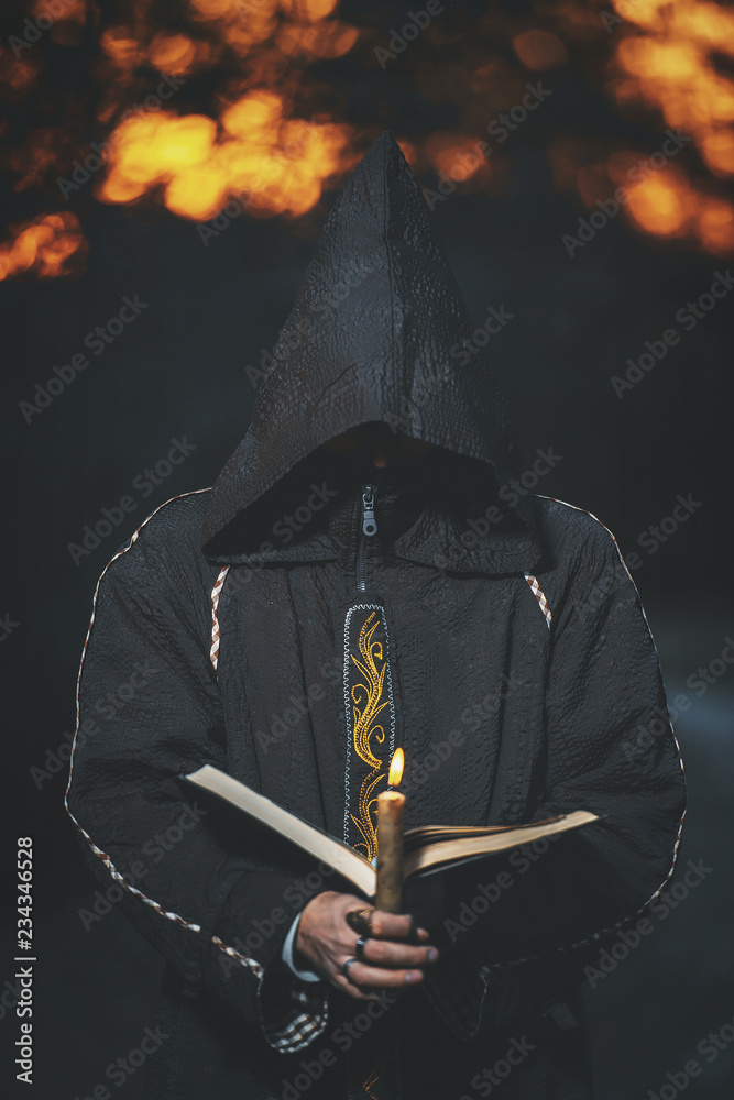 Cosplay black mage. A man dressed as a monk. A man in a black robe with