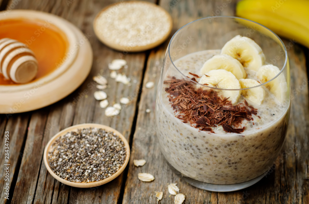 Overnight banana oats quinoa Chia seed pudding decorated with fresh banana slices and chocolate Overnight banana oats quinoa Chia seed pudding decorated with fresh banana slices and chocolate
