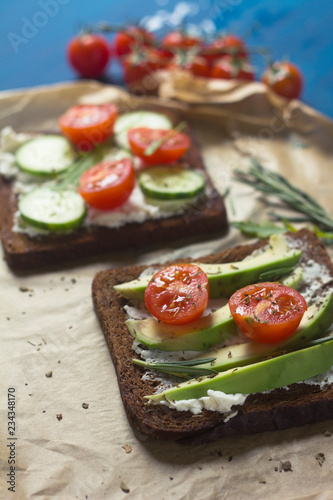sandwiches with ricotta, avocado, cherry tomatoes and cucumbers