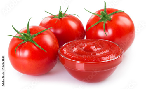 Fresh tomatoes with ketchup on white background