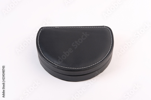 Black leather case stitched with white threads, semicircular shape on an isolated white background