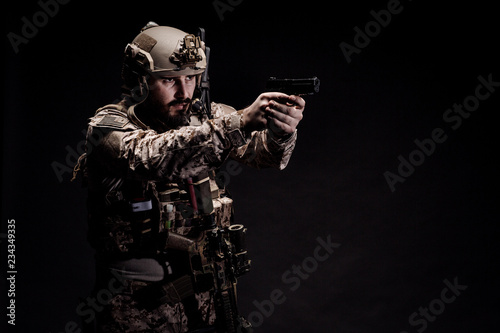 soldier or private military contractor holding rifle. Image on a black background. war  army  weapon  technology and people concept