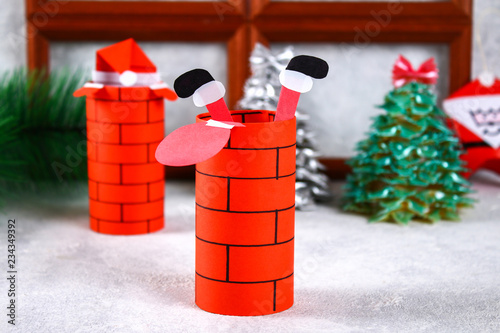 Wallpaper Mural Christmas Santa Claus in chimney made from toilet paper hub, colored paper, marker, glue, fishing line and cotton pad. DIY toy on the Christmas tree. Handmade Guide, step by step. Christmas decor. Torontodigital.ca