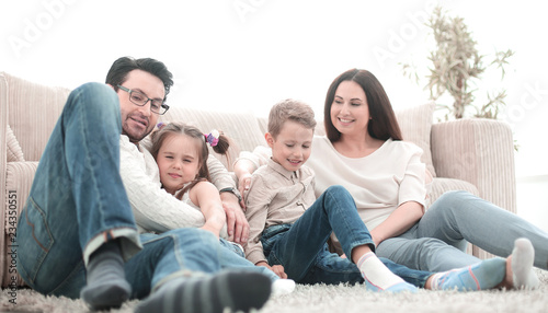 happy family rests in the living room on a free evening © ASDF