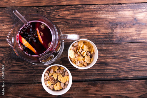Decorated composition of mulled wine in jug on wooden table