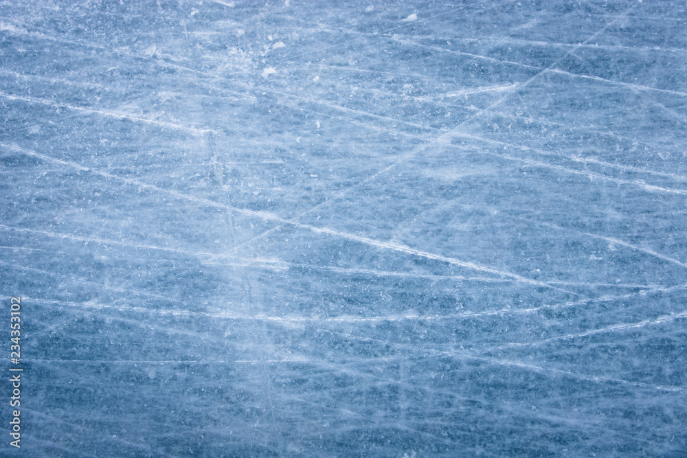 Skating ice rink texture covered in daylight.Close up of blue ice