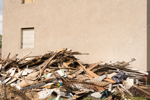 Pile of construction waste and blank wall - building, timber, boards, wall - copy space photo