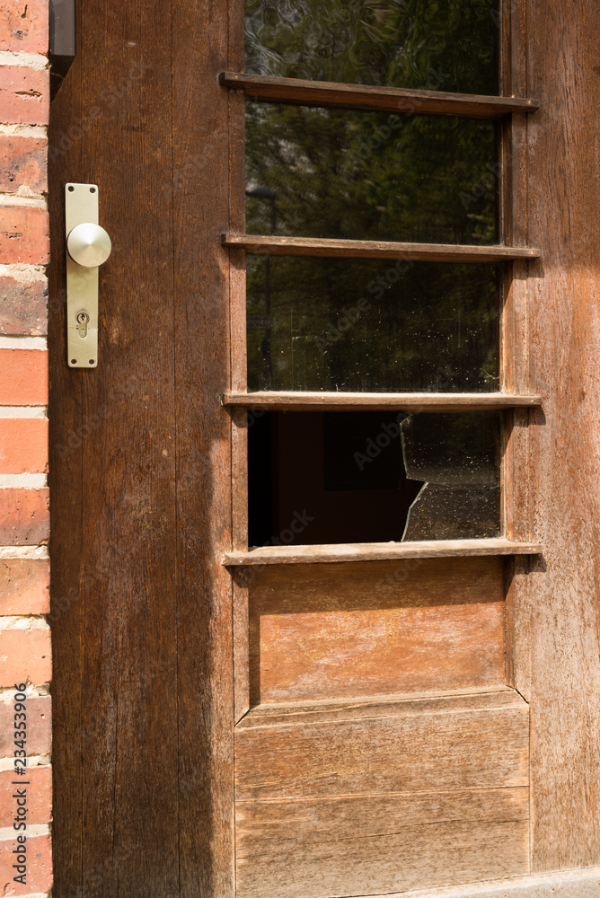 Broken glass window in door - crime, robbery, home invasion, abandoned Broken glass window in door - crime, robbery, home invasion, abandoned