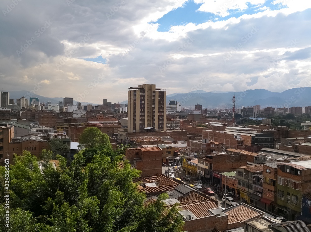 Fototapeta premium Medellin, Colombia, downtown with brick buildings and concept of development and strength. Partly cloudy day with lots of sunlight.