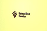 3D illustration of Education Center, brown color and brown text with yellow background.