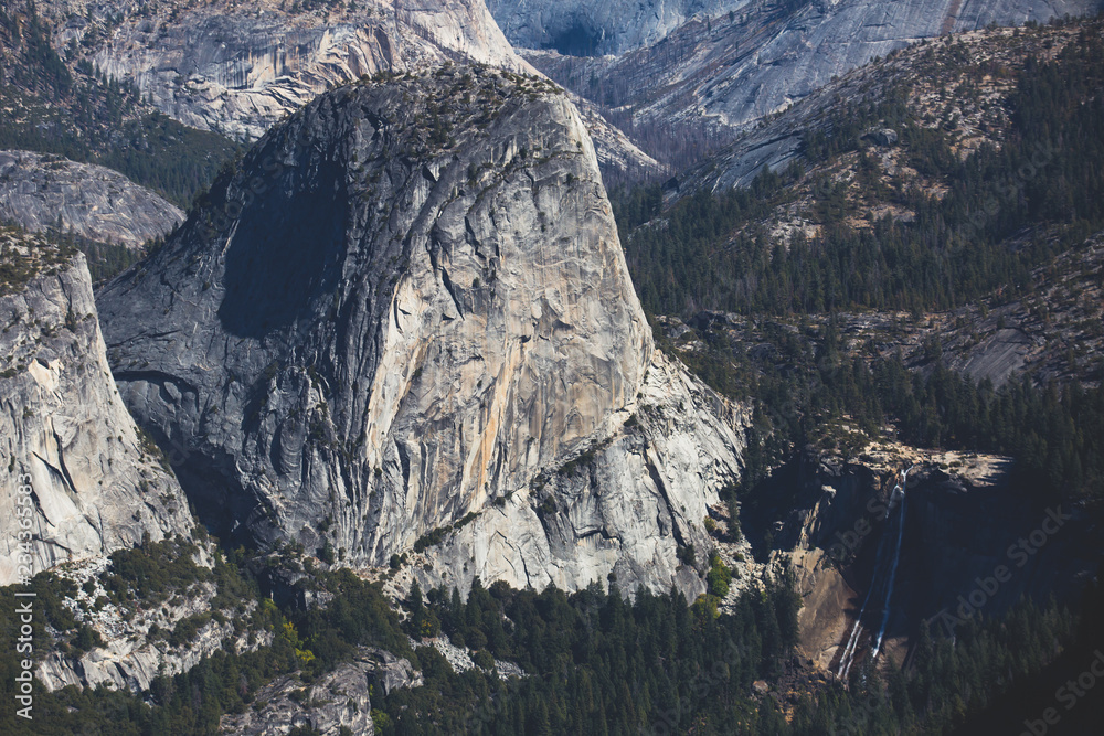 Panoramic summer view of Yosemite valley with Half Dome mountain, Tenaya Canyon, Liberty Cap, Vernal Fall and Nevada Fall, seen from Glacier point overlook, Yosemite National Park, California