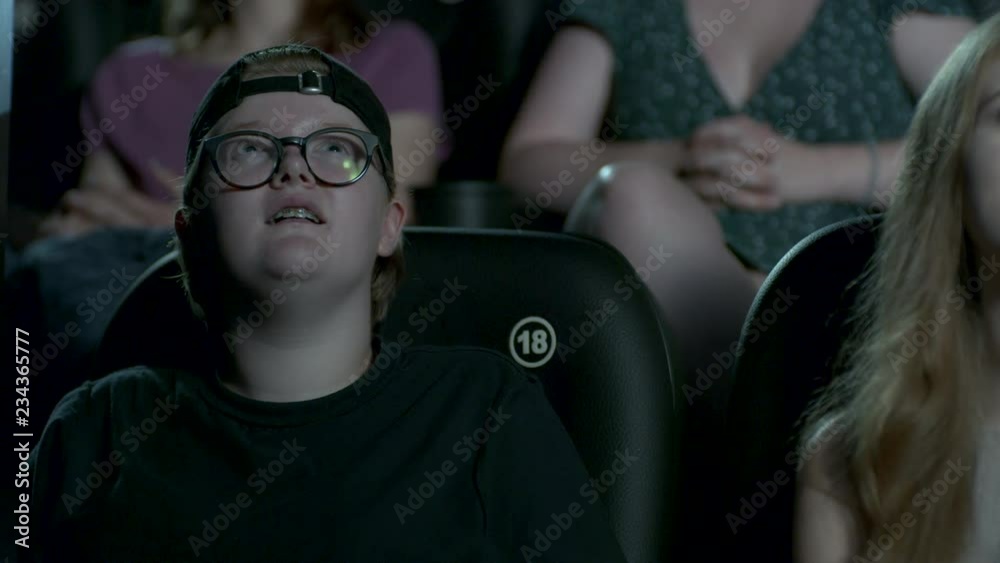 Young woman watching a film at the cinema. Young woman watching a film at the cinema.
