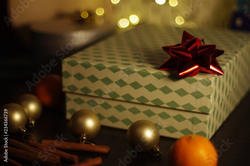 Ornamental gift box with red ribbon on top