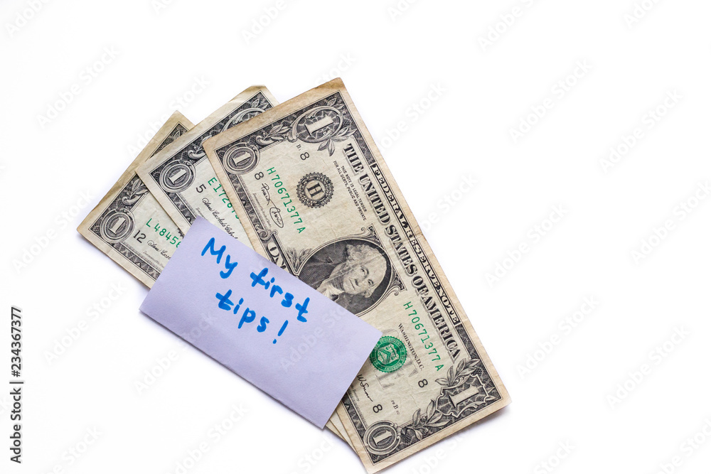 Banknotes of 1 american dollar isolated on white background. First earned money. Tips in restaurant. Copy space for text Banknotes of 1 american dollar isolated on white background. First earned money. Tips in restaurant. Copy space for text