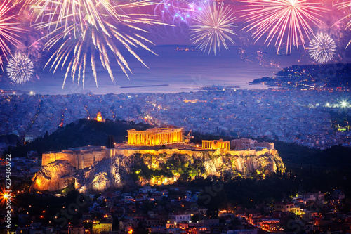cityscape of Athens with illuminated Acropolis hill and see with fireworks, Pathenon and sea at night with fireworks, Greece