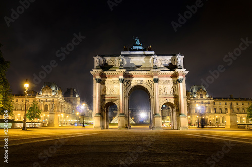 Triumphal Arch (Arc de Carrousel) and Louvre museum at background at night in Paris, France © zefart