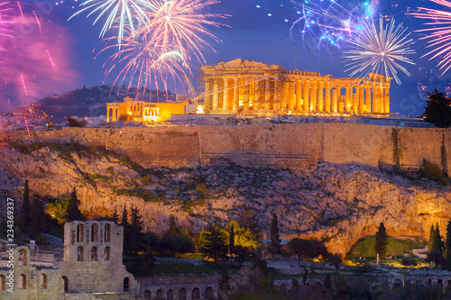 Famous skyline of Athens with Acropolis hill and Pathenon illuminated at night with fireworks, Athens Greecer