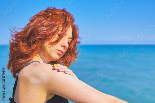 Woman applying sun protection cream. photo