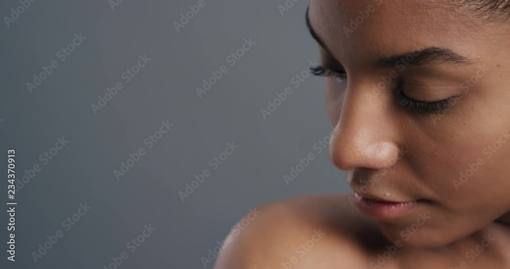 close up portrait beautiful african american woman touching bare shoulders with hands enjoying smooth healthy skin complexion perfect natural beauty on grey background