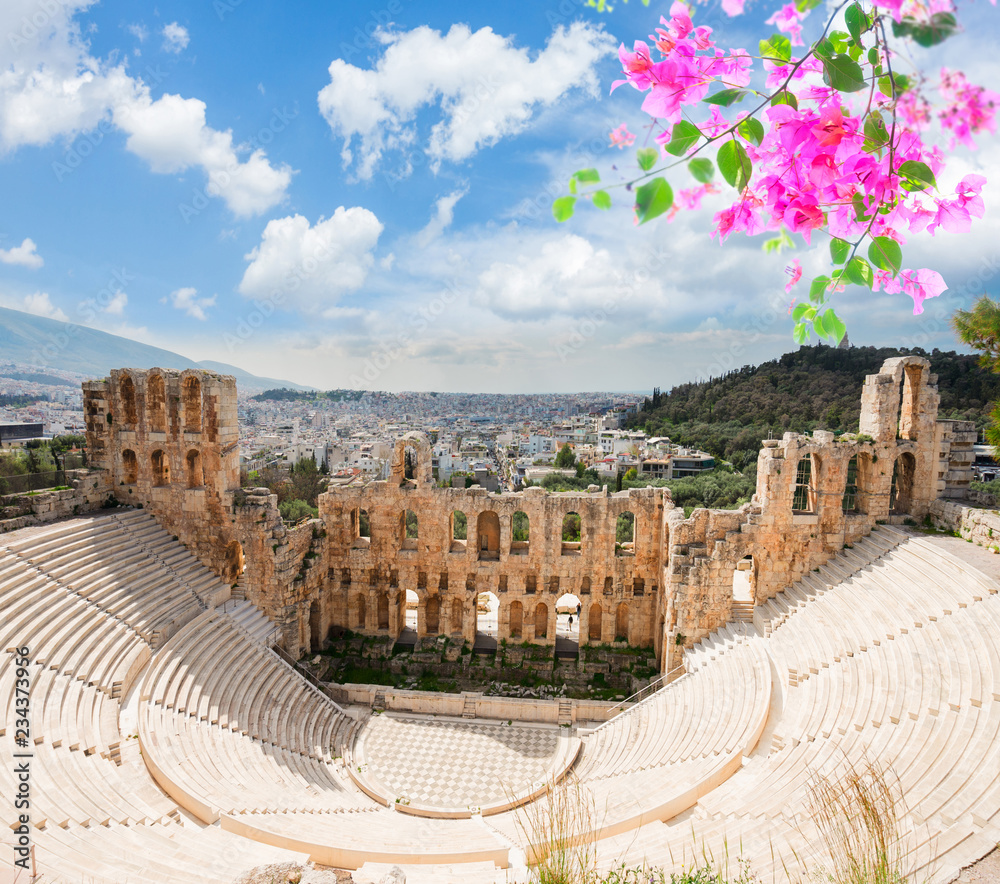 view of Herodes Atticus amphitheater of Acropolis with flowers, Athens, Greece