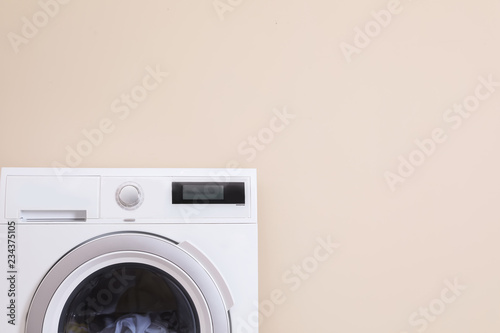 Washing machine and space for text on color background. Laundry day