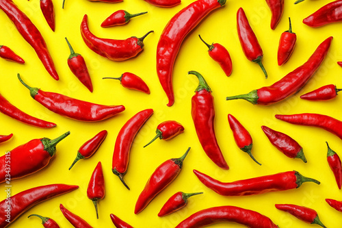 Flat lay composition with fresh chili peppers on color background