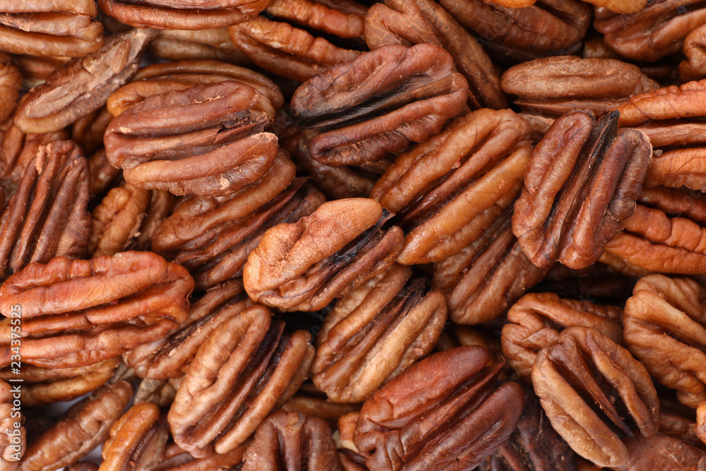 Shelled pecan nuts as background, top view. Nutritive food