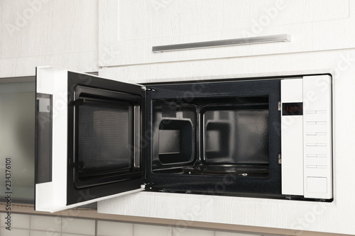 Canvas Print Open modern microwave oven built in kitchen furniture
