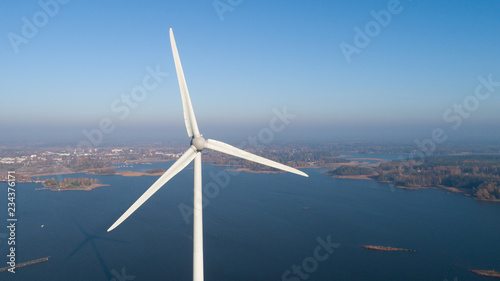 Aerial view of Windmill for electric power production and the city on background. Finland